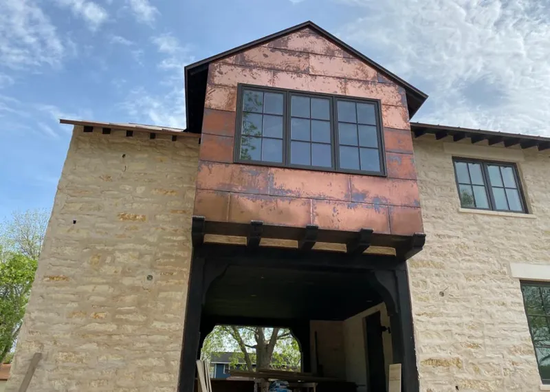 Copper metal panel facade on a stone building for Roof Repair in Fort Hood
